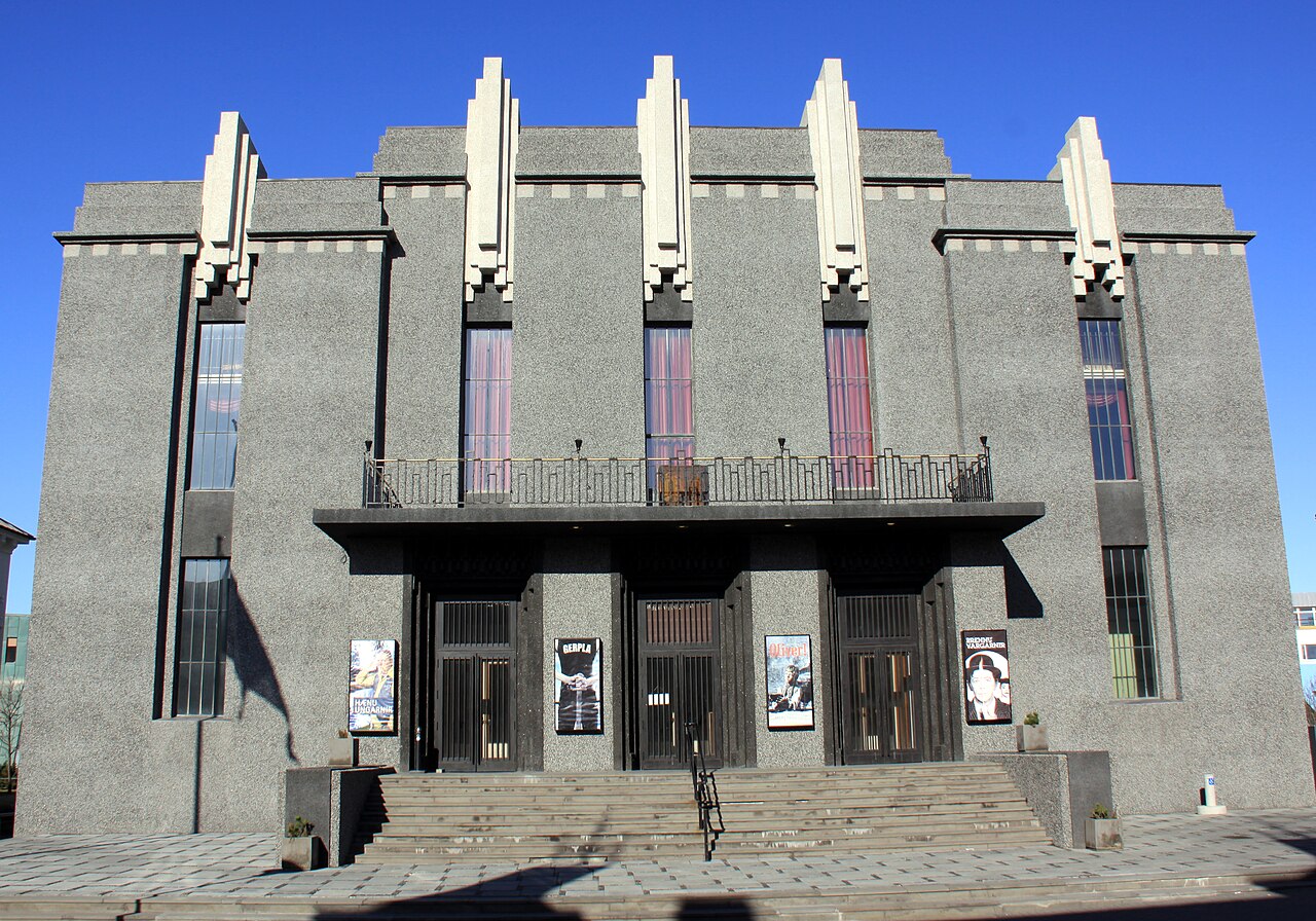 The symmetrical front of the National Theatre, with stepped decorative columns above its entrance.
