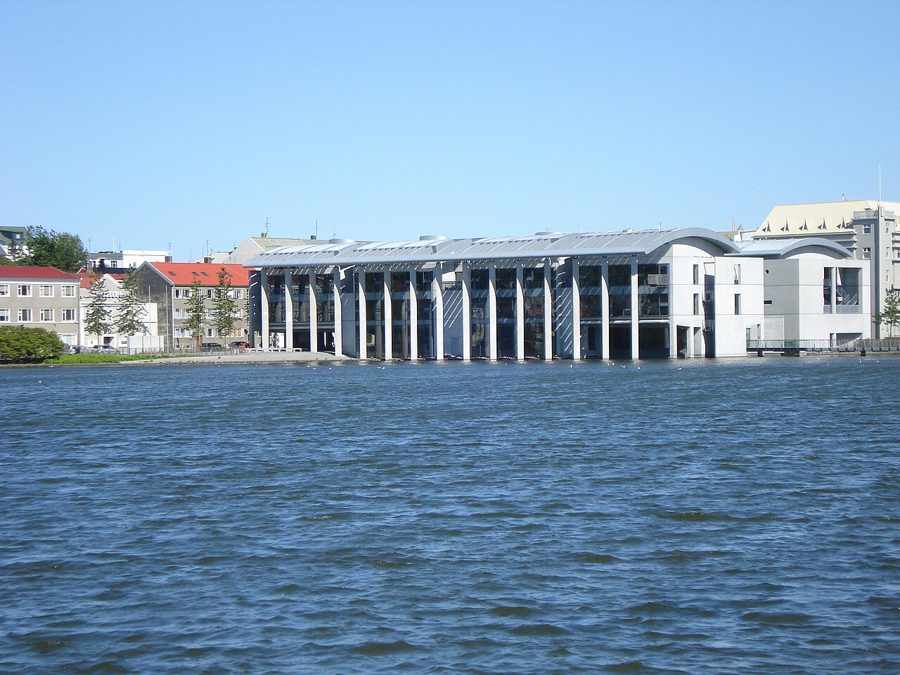 Reykjavík City Hall with its glass-fronted facade beside Tjörnin.